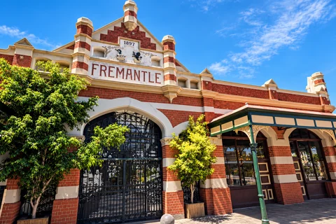 The red-brick heritage facade and main entrance of Fremantle Markets