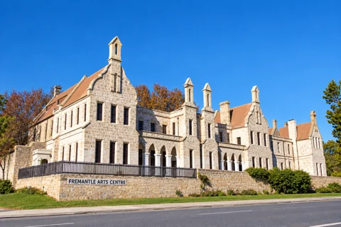 The limestone facade, arched verandahs and gables of Fremantle Arts Centre