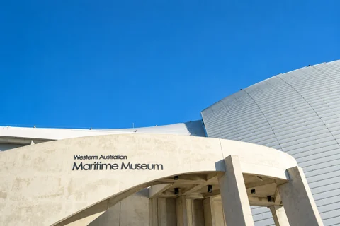 The curved entrance facade and metal roof of the WA Maritime Museum in Fremantle