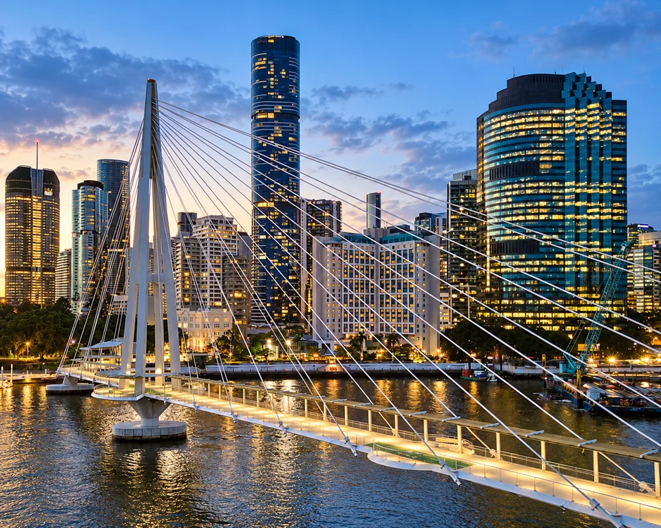 The pale cable-stayed Kangaroo Point Bridge crosses the Brisbane River in front of illuminated CBD towers