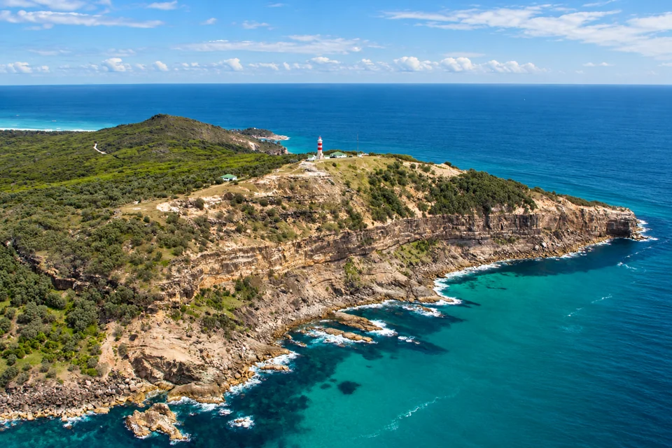 Cape Moreton’s sandstone headland and red-and-white lighthouse on Moreton Island