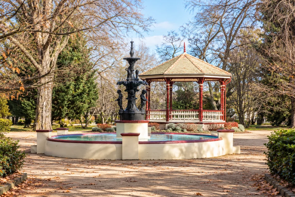 The cast-iron fountain and red-and-cream bandstand in Cook Park, Orange