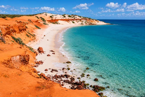 Red cliffs and a pale beach at Cape Peron in Francois Peron National Park