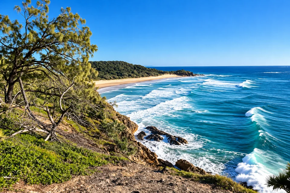 Surf below the rocky Point Lookout headland with Frenchmans Beach behind on North Stradbroke Island.